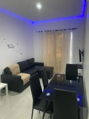 a living room with a couch and a table with chairs at Apartamento em Pedra Badejo in Pedra Badejo