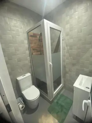 a bathroom with a toilet and a shower and a sink at Apartamento em Pedra Badejo in Pedra Badejo