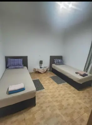 two beds sitting in a room with at 1 chambre proche aeroporto cabo verde in Espargos