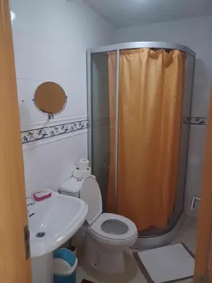 a bathroom with a shower and a toilet and a sink at Gamboa Djeu in Praia