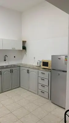 a kitchen with white cabinets and a white refrigerator at Flat Mindelo 30 in Mindelo