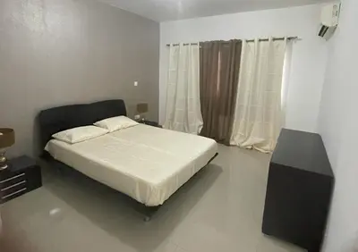 a bedroom with a bed with a speaker and a window at Meraki's Apartment in Praia