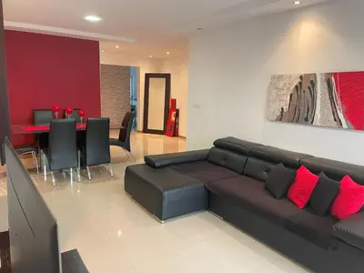 a living room with a couch and a dining room at Meraki's Apartment in Praia