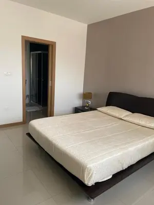 a bedroom with a large bed with a white mattress at Meraki's Apartment in Praia