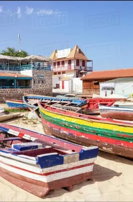 a group of colorful boats sitting on the beach at Oceanfront Apt 25 Porto Antigo II in Santa Maria