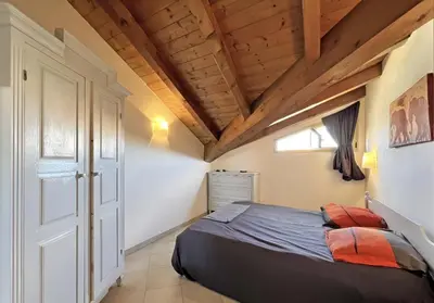 a bedroom with a bed and a wooden ceiling at Bright Top Floor with Terrace in Santa Maria