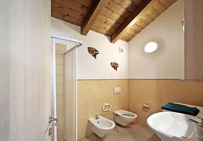 a bathroom with a toilet and a sink at Bright Top Floor with Terrace in Santa Maria