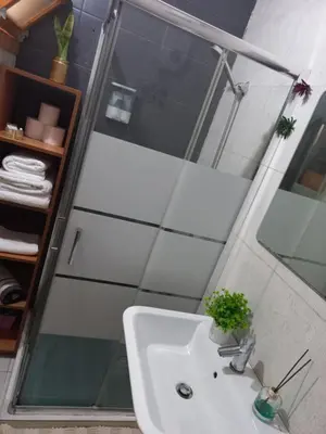 a bathroom with a sink and a glass shower at Brisa e Paz in Praia
