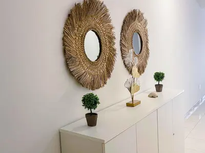 two mirrors on a wall with two plants on a shelf at Apartamento Paradise in Santa Maria