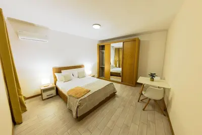 a bedroom with a bed and a table and a mirror at Jet Ap & Car 12 - AC in Praia