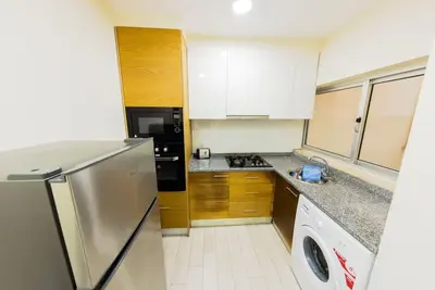 a kitchen with a stainless steel refrigerator and a dishwasher at Jet Ap & Car 12 - AC in Praia