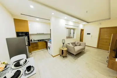 a kitchen and living room with a couch and a table at Jet Ap & Car 12 - AC in Praia