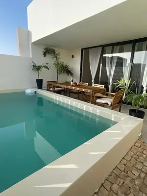 a swimming pool in a house with a dining room at Lagoon Apartment mit Pool Boa Vista in Sal Rei