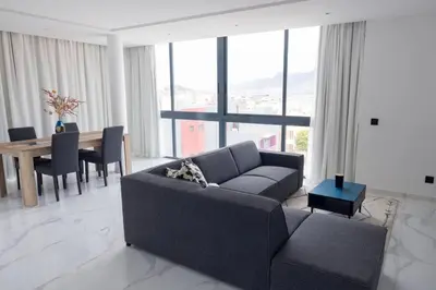 a living room with a couch and a table at Bliss Apartments T2 - Julia in Mindelo