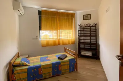 a bedroom with a bed and a window at A Baia do Fortim in Mindelo