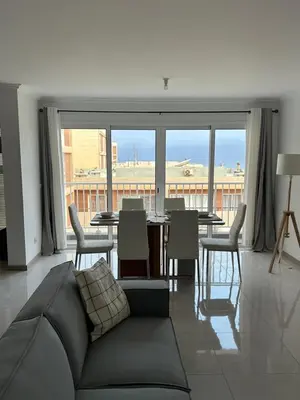 a living room with a couch and a table with chairs at Laginha Views in Mindelo
