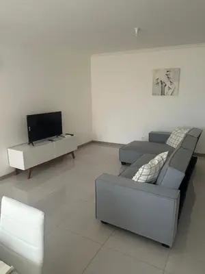a living room with a couch and a tv at Laginha Views in Mindelo