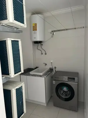 a small kitchen with a washing machine and a sink at Laginha Views in Mindelo