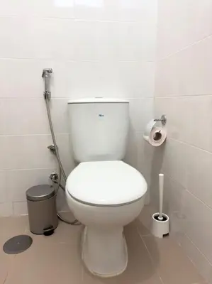a bathroom with a white toilet in a stall at 2 bdr cozy apt in Terra Branca, Free Wifi - LCGR in Praia