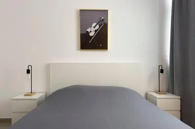 a bedroom with a bed and a picture on the wall at 2 bdr cozy apt in Terra Branca, Free Wifi - LCGR in Praia