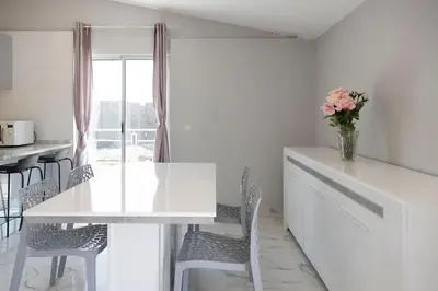 a white kitchen with a white table and chairs at 2 bdr cozy apartment in city center, Wifi - LCGR in Assomada