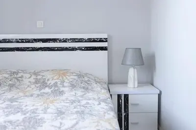 a bedroom with a bed and a nightstand with a lamp at 2 bdr cozy apartment in city center, Wifi - LCGR in Assomada