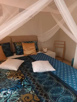 a bed with pillows on it in a room at Ocean Dream BeachHouse Boa Vista in Sal Rei