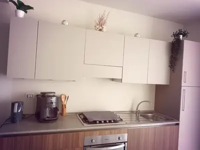 a kitchen with white cabinets and a counter top at Ocean Dream BeachHouse Boa Vista in Sal Rei