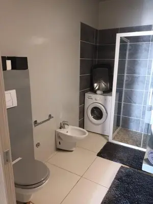 a bathroom with a toilet and a washing machine at Ocean Dream BeachHouse Boa Vista in Sal Rei