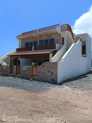 a house with a staircase in front of it at Vila de Matiz in Vila do Maio