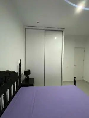 a bedroom with a bed with a purple blanket at Apartamento Rua do museu dos Náufragos in Sal Rei
