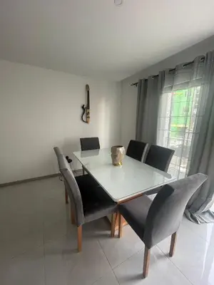 a dining room with a white table and chairs at Appartement standing praia in Praia
