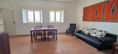 a living room with a table and chairs and a couch at APARTMENT SALINAS VILA DO MAIO WiFi FREE in Vila do Maio