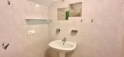 a white bathroom with a sink and a mirror at APARTMENT SALINAS VILA DO MAIO WiFi FREE in Vila do Maio