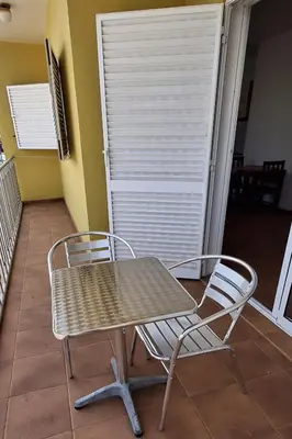 a table and two chairs sitting on a porch at APARTMENT SALINAS VILA DO MAIO WiFi FREE in Vila do Maio