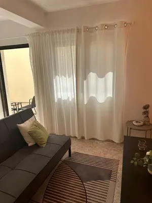 a living room with a couch and a window at Coração de Santa Maria in Santa Maria