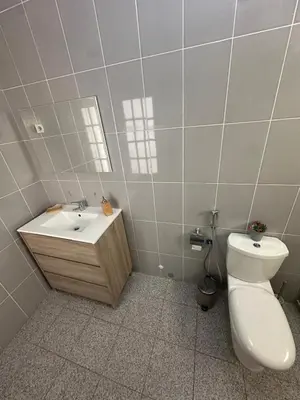 a bathroom with a toilet and a sink and a mirror at Coração de Santa Maria in Santa Maria