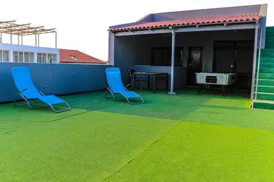 two blue chairs on a patio with a table at Coração de Santa Maria in Santa Maria