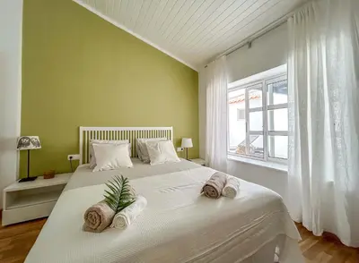 a bedroom with a large bed with towels on it at Un hogar lejos de tu hogar in Sal Rei