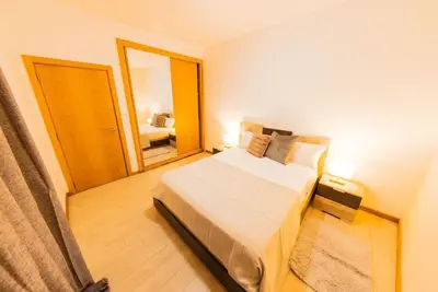 a small bedroom with a bed and a mirror at Jet Ap & Car 23 in Praia