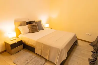 a bedroom with a large bed in a room at Jet Ap & Car 23 in Praia
