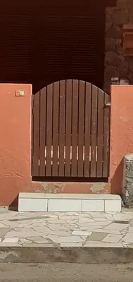 a wooden gate in front of a building at Padaria Portuguesa, with porch facing the street in Santa Maria