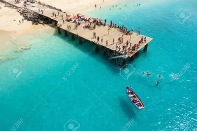 a group of people on a pier over the beach at Padaria Portuguesa, with porch facing the street in Santa Maria