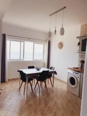 a kitchen and dining room with a table and chairs at Residencia Solimar in Ponta do Sol