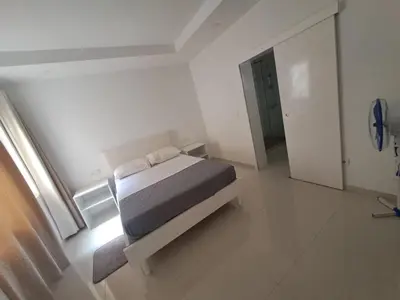 a bedroom with a bed in a white room at Bela's house in Mindelo