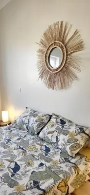 a bedroom with a bed and a mirror on the wall at Surfhouse Boavista in Sal Rei