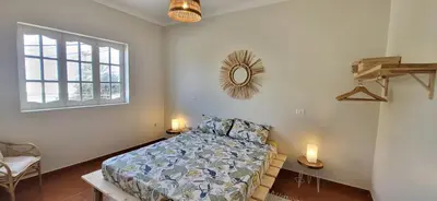 a bedroom with a bed and a mirror on the wall at Surfhouse Boavista in Sal Rei