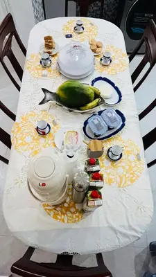a table with a meal with a fish on it at Hostel Rocha Marisol in Ponta do Sol