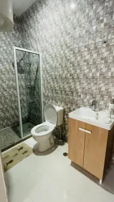 a bathroom with a toilet and a sink at Hostel Rocha Marisol in Ponta do Sol