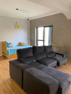 a living room with a couch and a bed at Casa Aconchego - T2 in Espargos